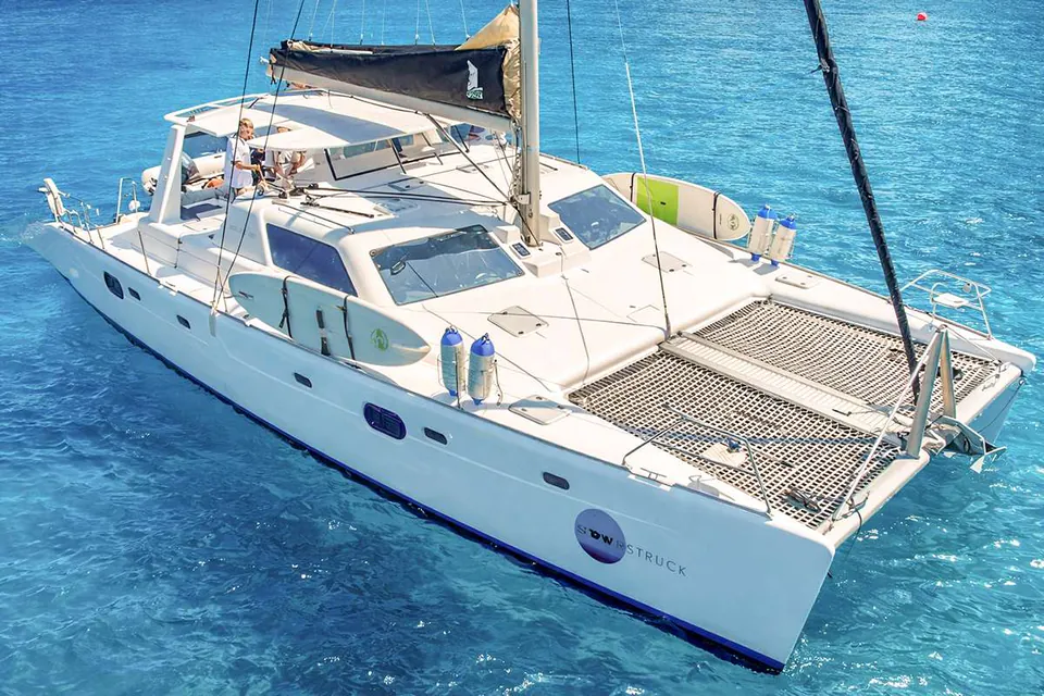 Moonstruck from the air at anchor in turquoise water, paddleboards along the rail