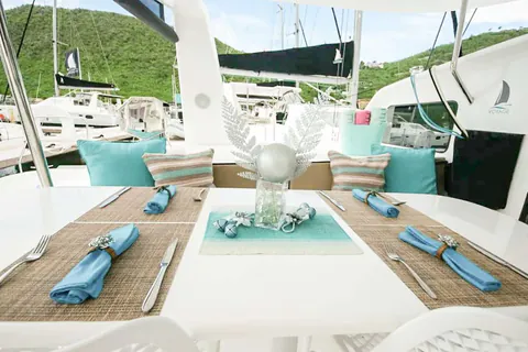 Cockpit table set for dinner with turquoise napkins